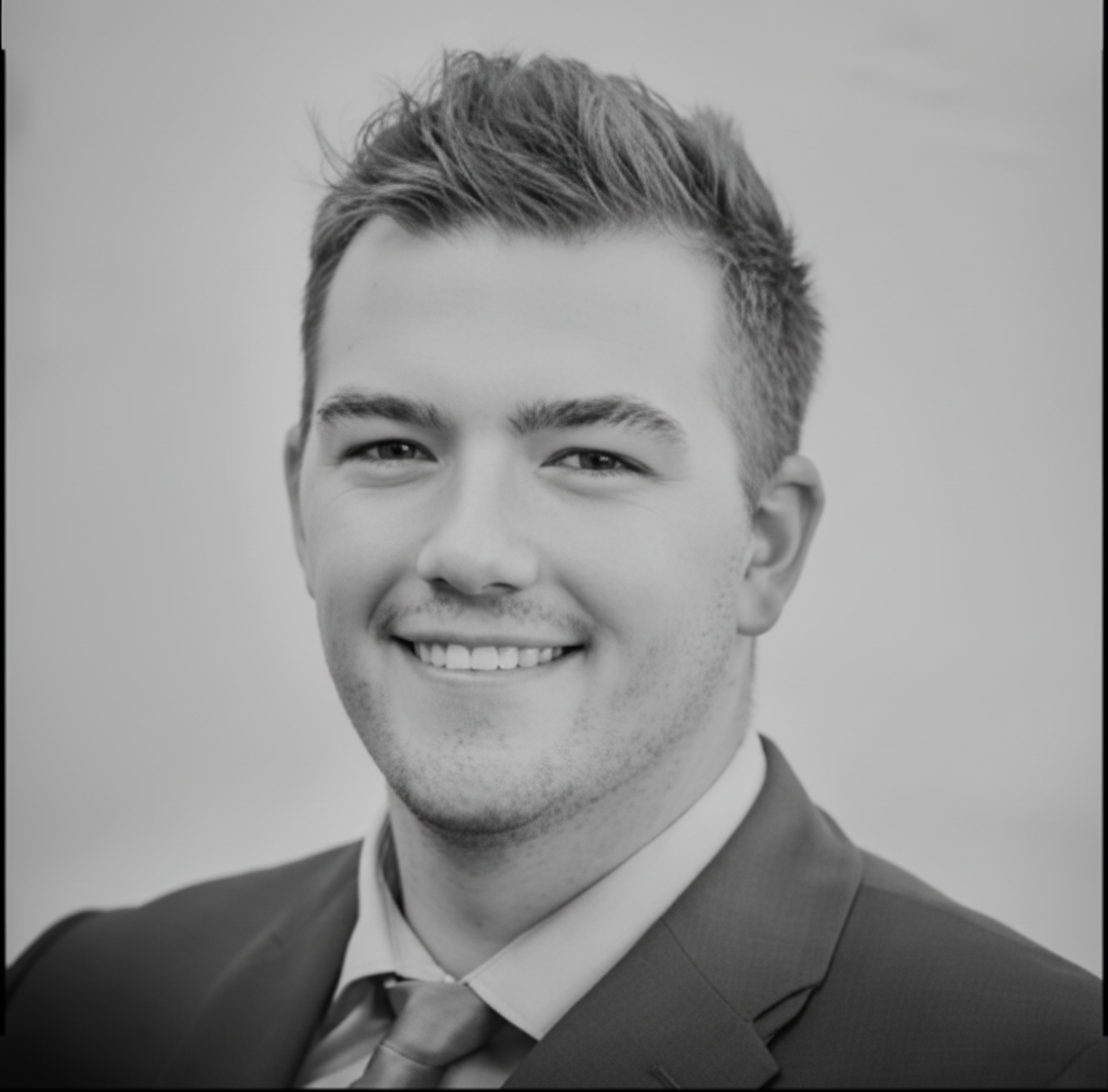 Black and white portrait of a dance instructor against a light background.